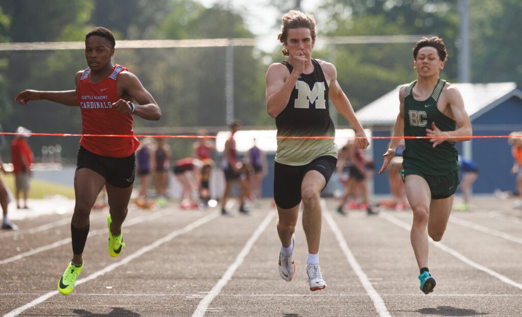 Meridian's Jase Klinkhammer keeps an eye on the finish line trailed closely by two competitors.