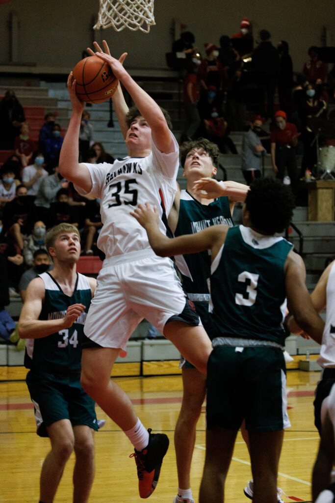 Bellingham's Henry Sheldrup tries for a shot at the basket while under pressure from defenders.