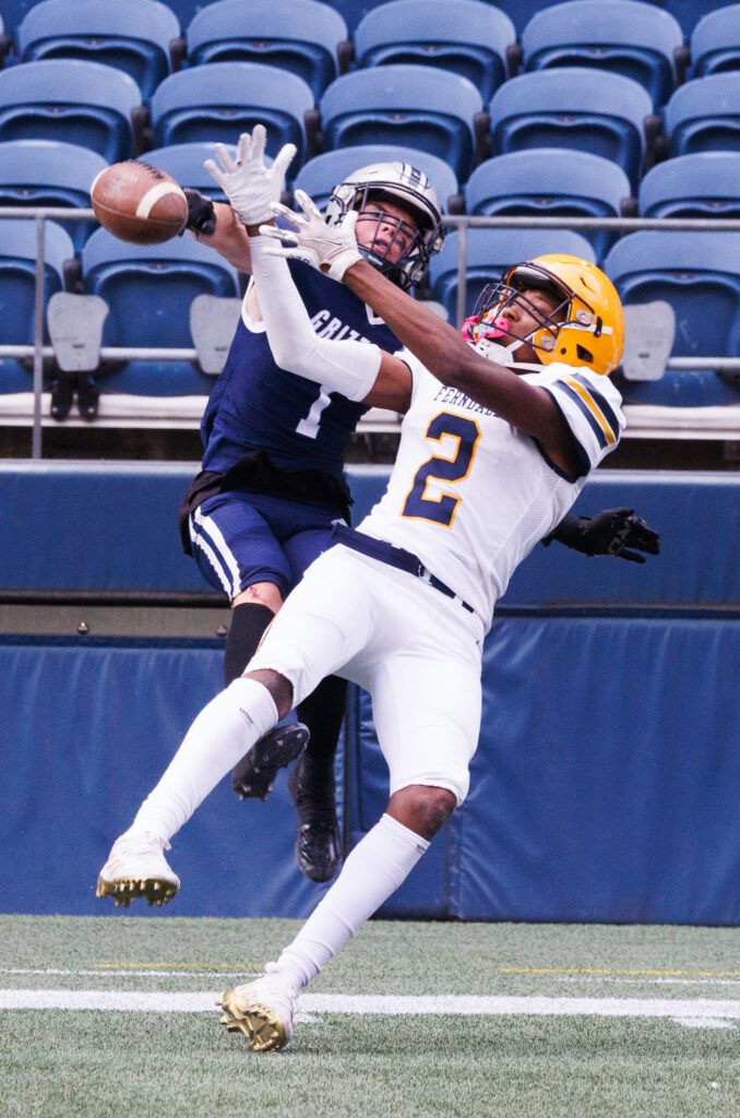 Ferndale’s Damien Toney has his reception blocked mid-air by Glacier Peak's Gabe Russell in the second quarter.