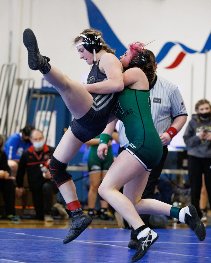 Mount Vernon's Samara Knudsen throws Meridian’s Regan Swope to the mat by lifting her from behind.