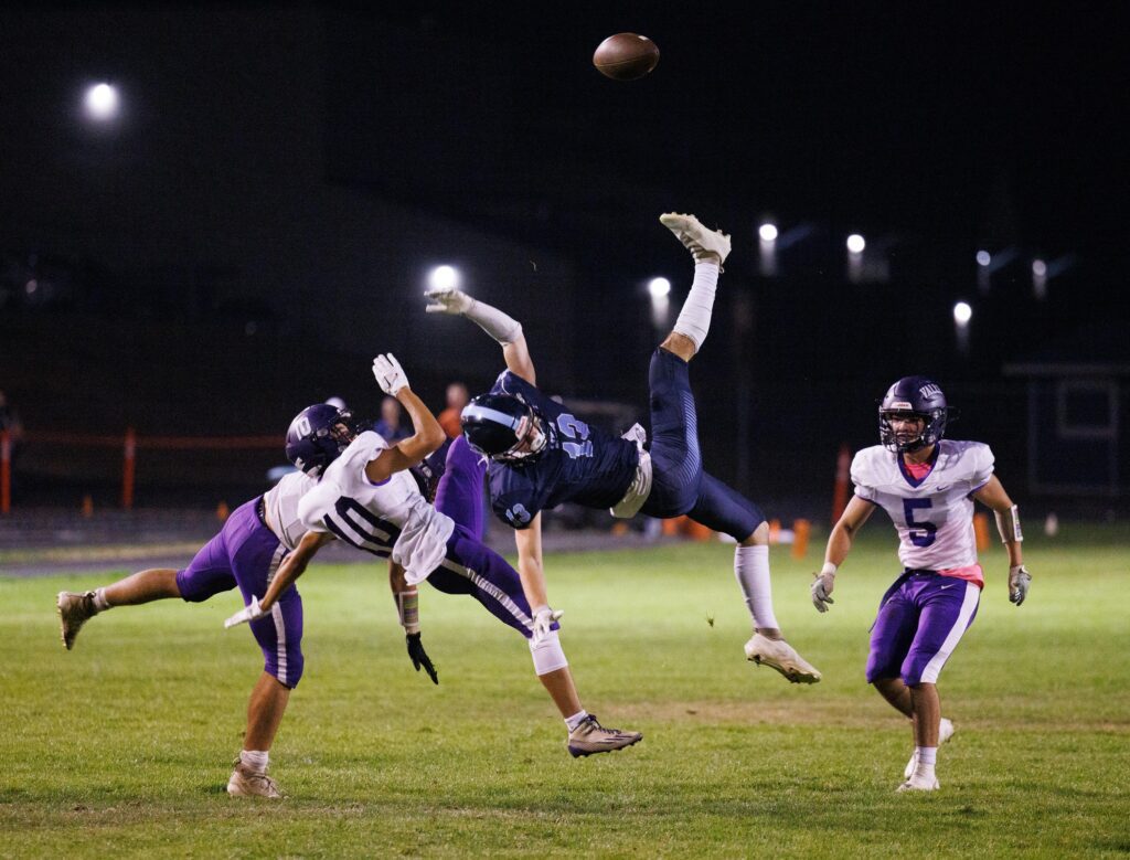 Bodies go flying as Nooksack Valley's Thomas Abell and Lynden Christian's Tyler Sipma go up for a pass and collide.