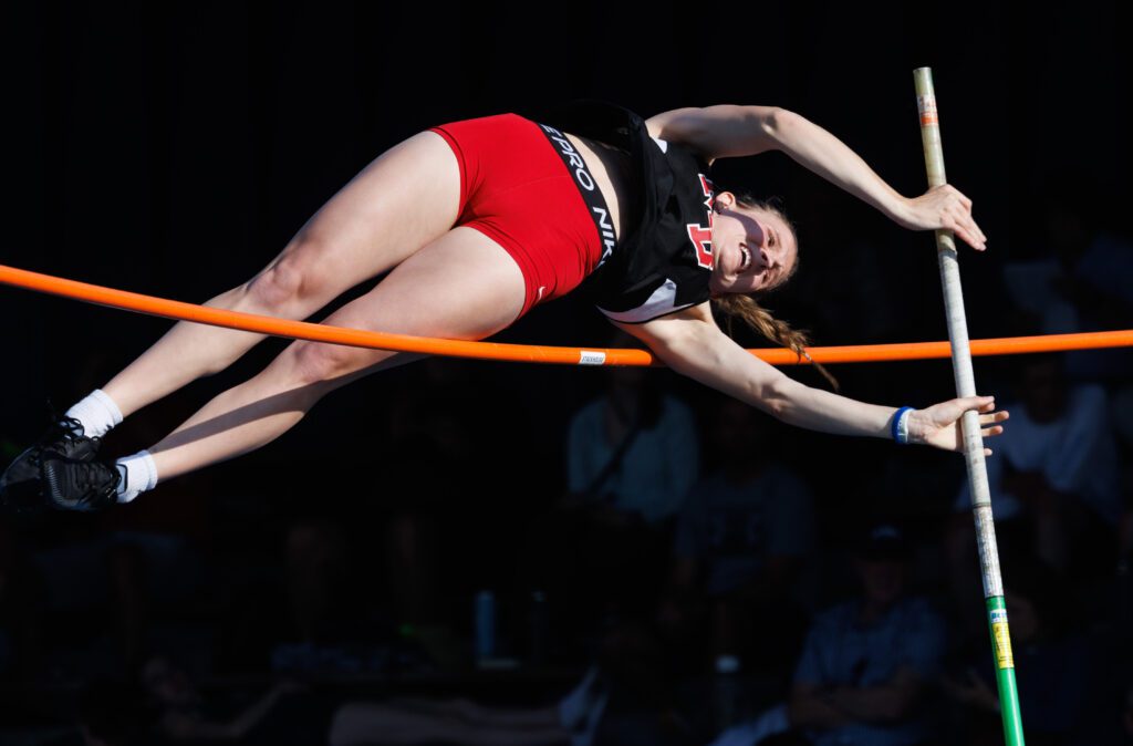 Mount Baker's Natalie Horsmon attempts to bring her legs over the bar.