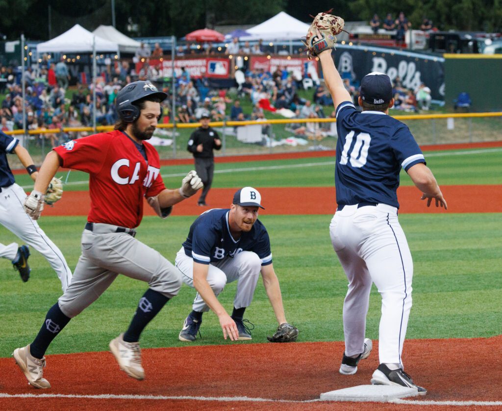 Pitcher Trevin Hope ducks down as the final out of an inning is made at first base.