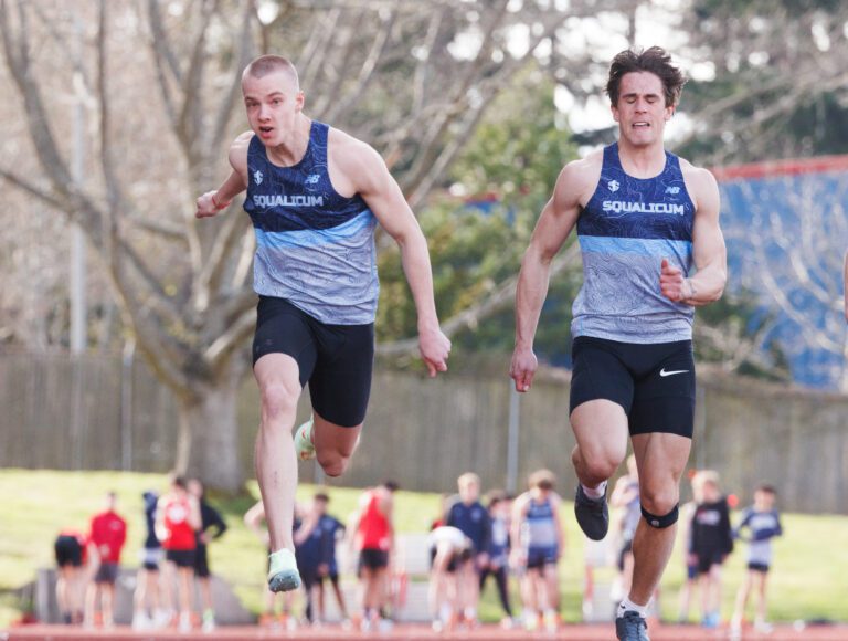 Squalicum's Andre Korbmacher, left, runs side by side with a teammate.