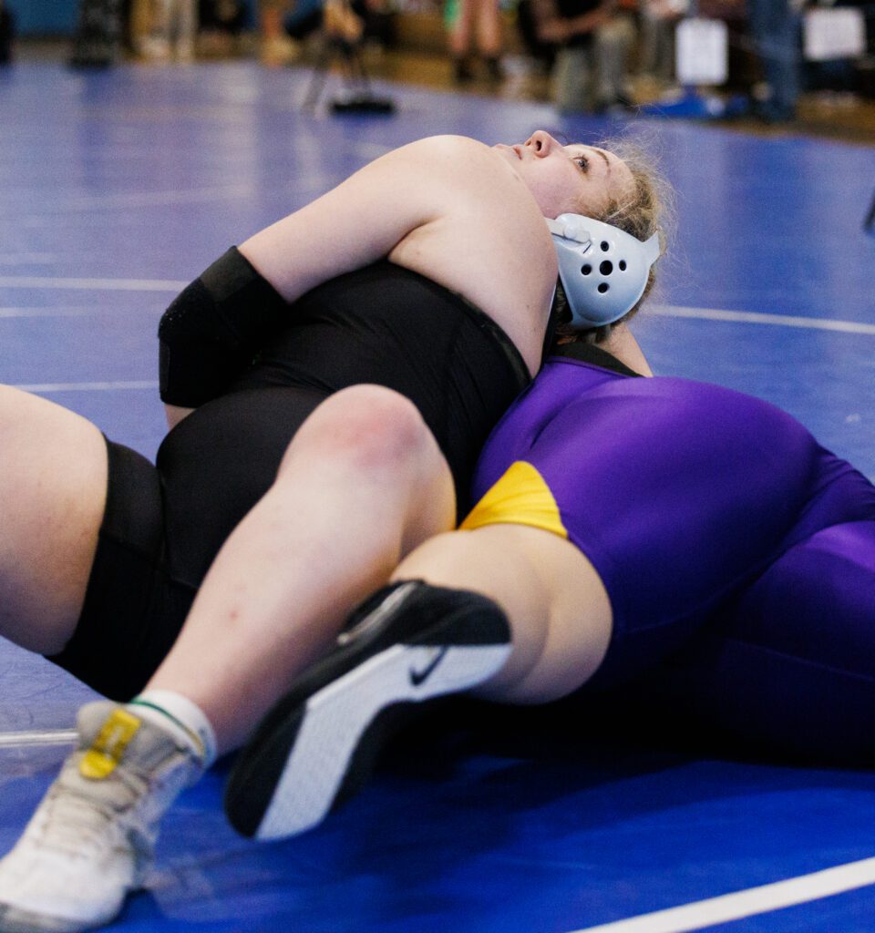 Lynden's Hannah Kayser looks up to the ceiling for a better posture to help pin her opponent to the mat.