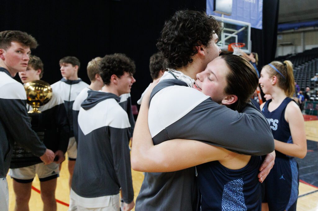 Lynden Christian’s Grace Hintz hugs her brother Jamison.