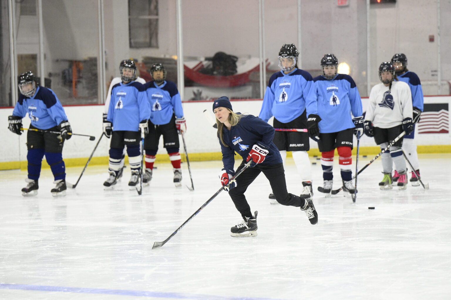 United States hockey player Haley Skarupa, front, demonstrates a drill in front of other team players.