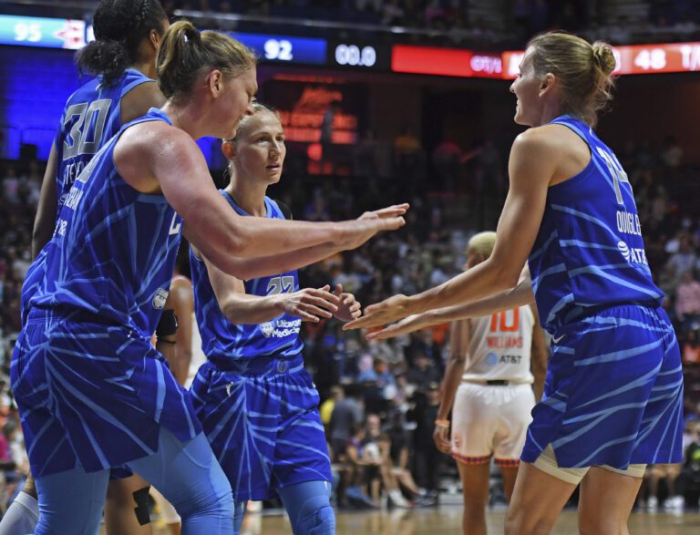 Chicago Sky guard Allie Quigley, right, congratulates teammates Emma Meesseman (33), Azurá Stevens (30) and Courtney Vandersloot (22).