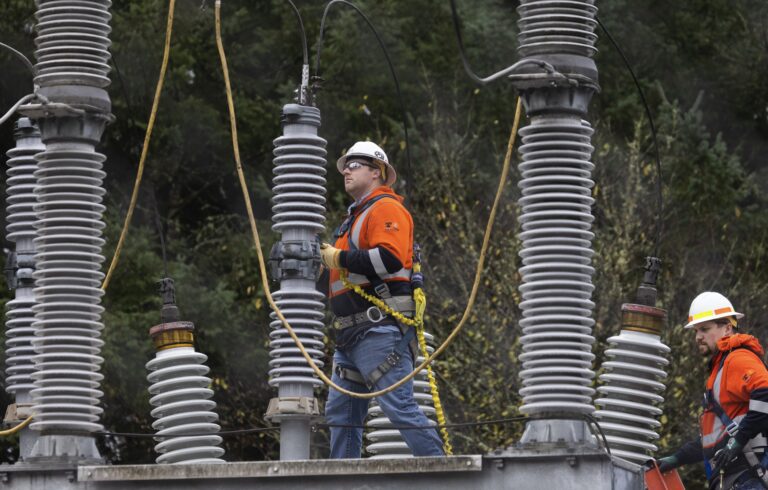 A Tacoma Power crew look over the electrical substation damaged by vandals.