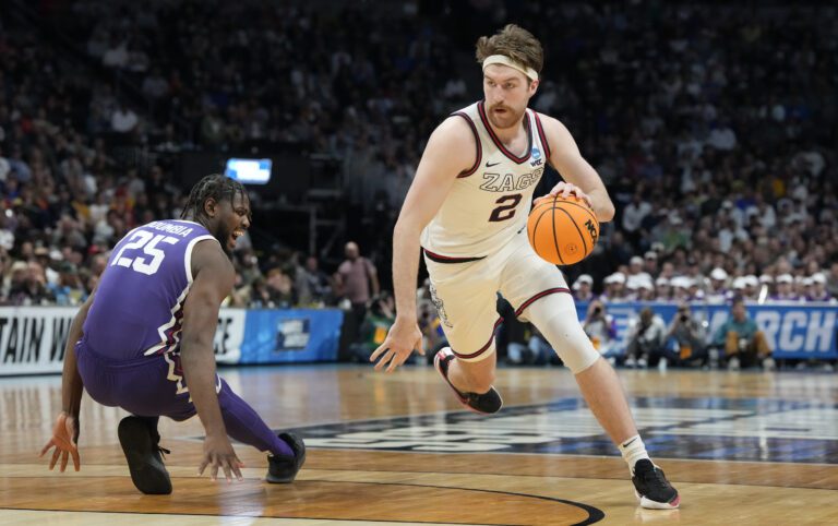 Gonzaga forward Drew Timme, right, drives the lane past TCU center Souleymane Doumbia with the ball in hand.