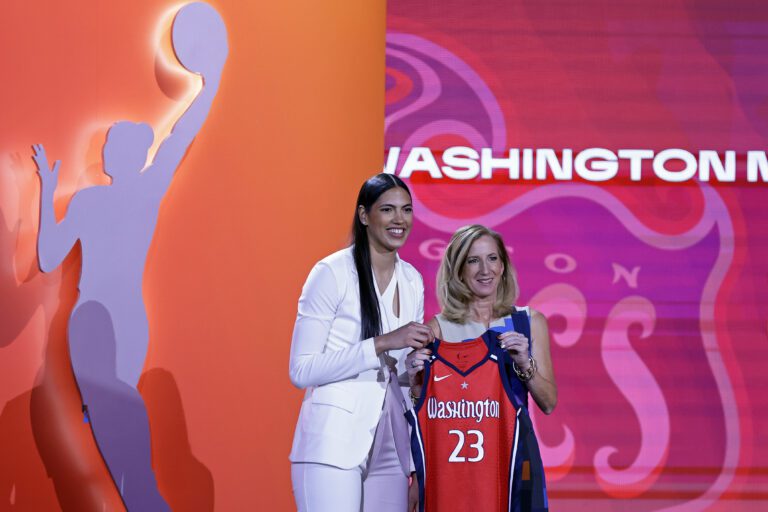 Iowa State's Stephanie Soares, left, poses with their awards for a photo with commissioner Cathy Engelbert