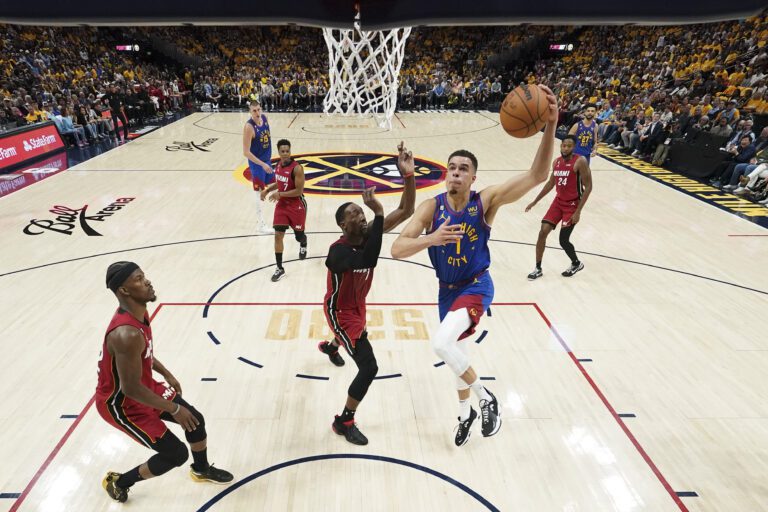 Denver Nuggets forward Michael Porter Jr. (1) shoots next to Miami Heat center Bam Adebayo.