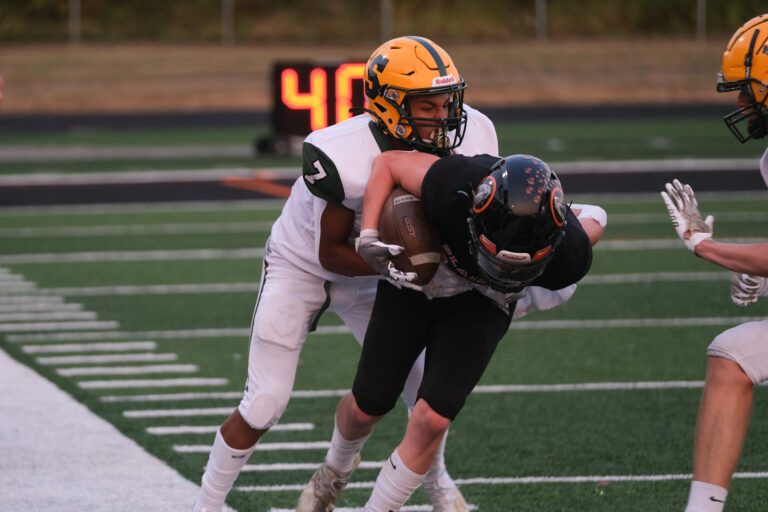 Andre Watson tackles Blaine's Riley Ihde as another player rushes to help.