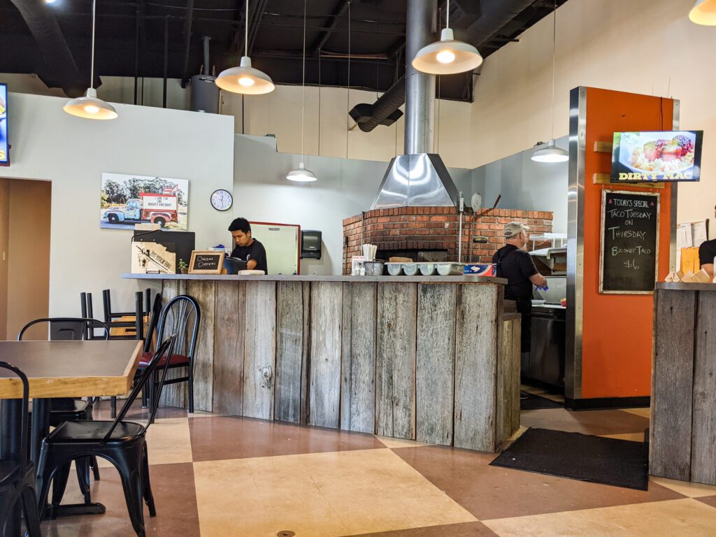 The inside space of Big Stick BBQ with a chalkboard letting customers know of specials available that day.