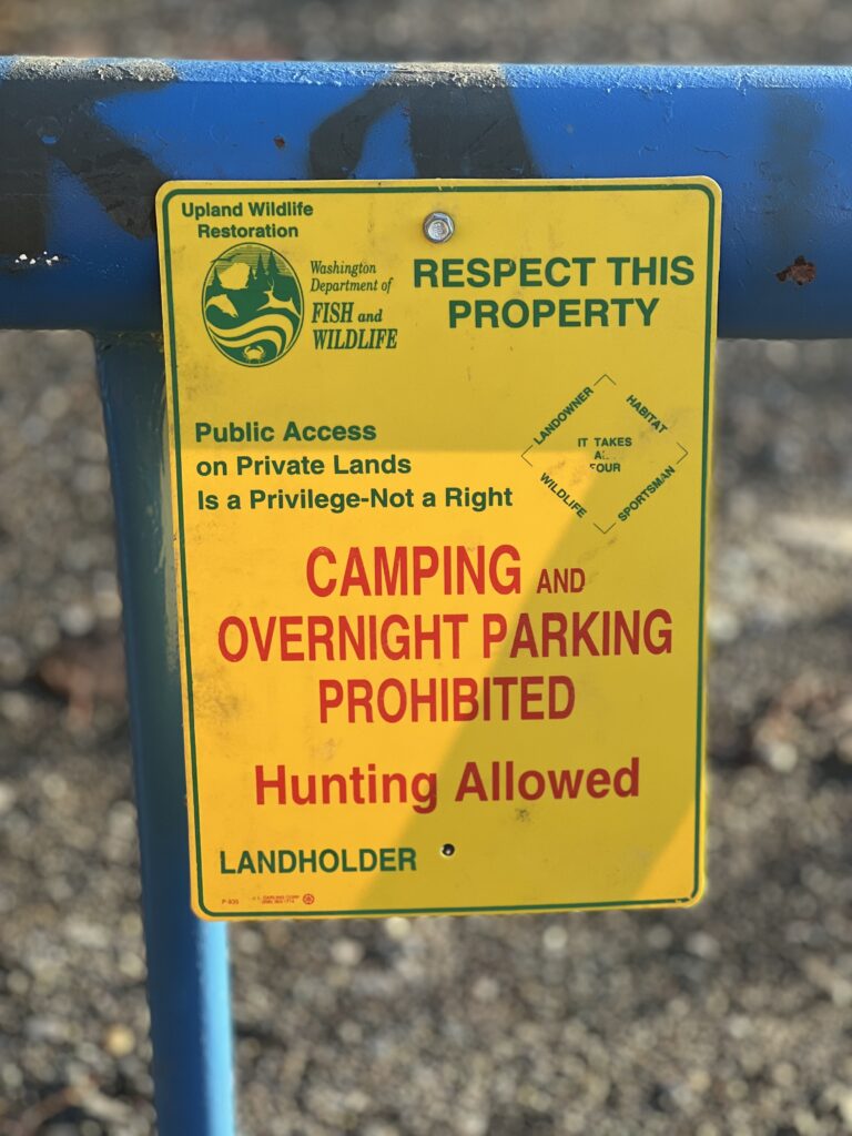 A state Fish and Wildlife sign posted on a Sierra Pacific gate warns visitors of the property's rules.