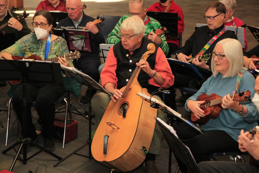 The Community Ukulele Players (CUP) perform on various ukulele as they sing along.