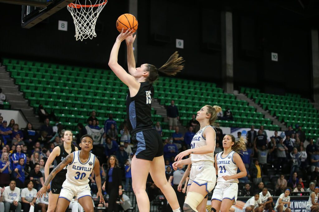 Sophomore Brooke Walling leaps above the defense to score.