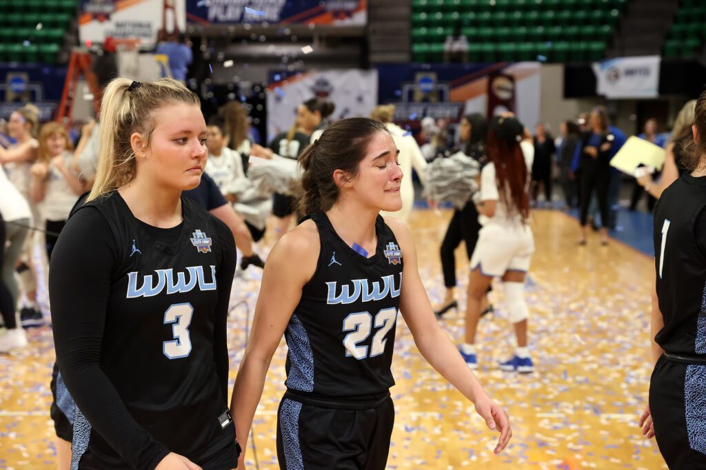 Freshman Riley Dykstra (left) and senior Gracie Castaneda walk off with somber expressions.