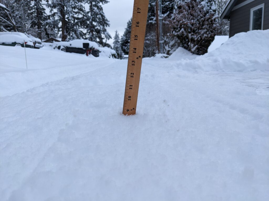 Nearly nine inches of snow are measured on Erie Terrace with a wooden ruler.