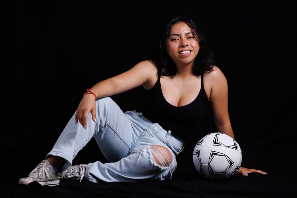 A photo of Wendy Cruz with a soccer ball.