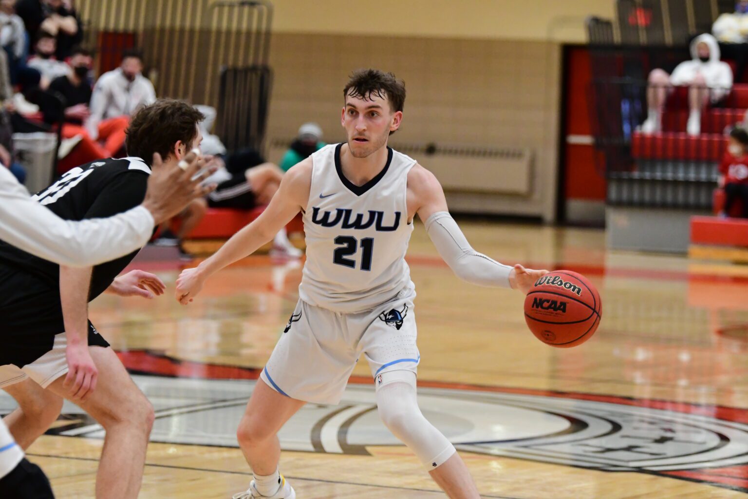 Western junior guard Lucas Holden look for an opening.