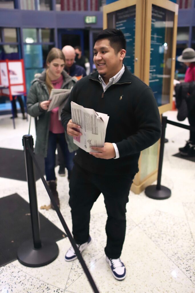 Jonathan Sanjuan with a stack of papers.