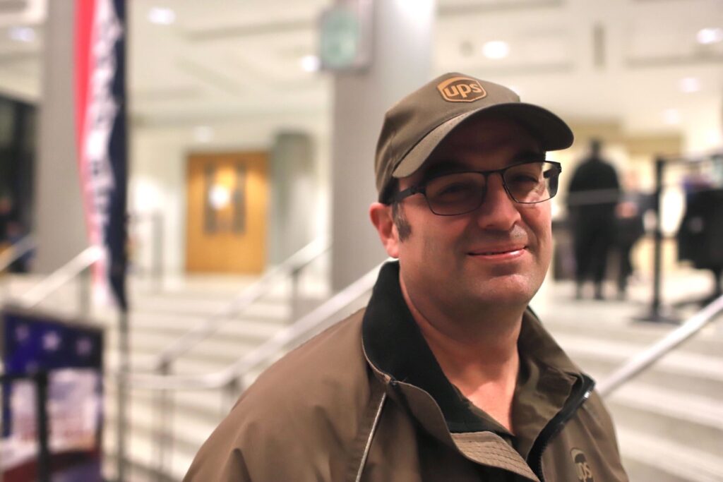 Shane Williams stands inside the courthouse on election night while dressed in the ups uniform.