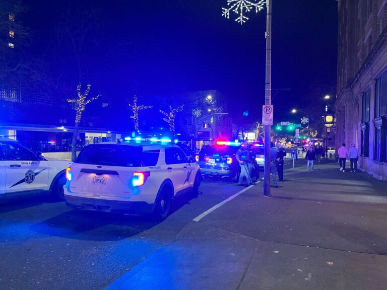 Bellingham Police shut down Holly Street as several police vehicles shine bright lights on the road.