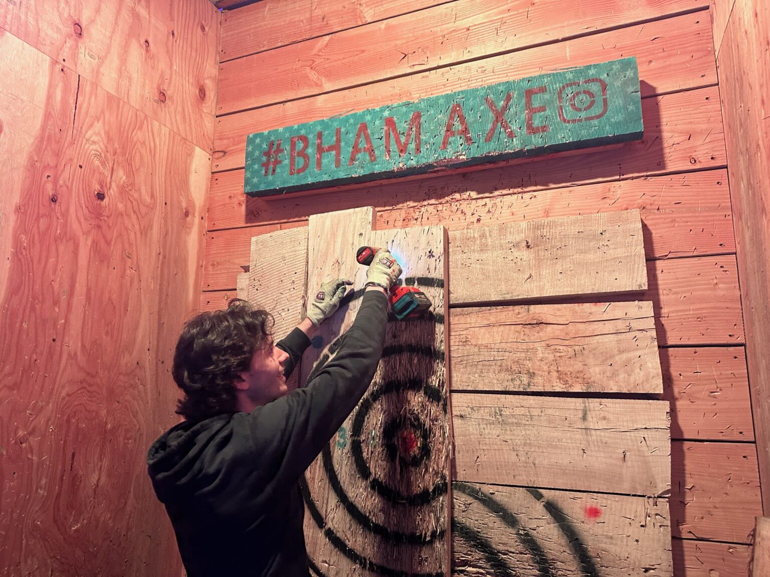 Employee Forest Gheen-Regouski replaces one of the wooden targets at Bellingham Axe.