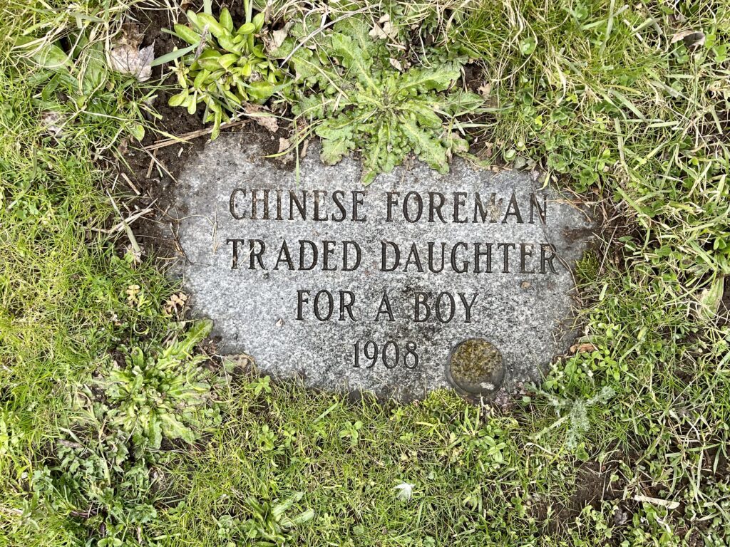 A tombstone explains a vague situation of a Chinese foreman trading a daughter for a boy.