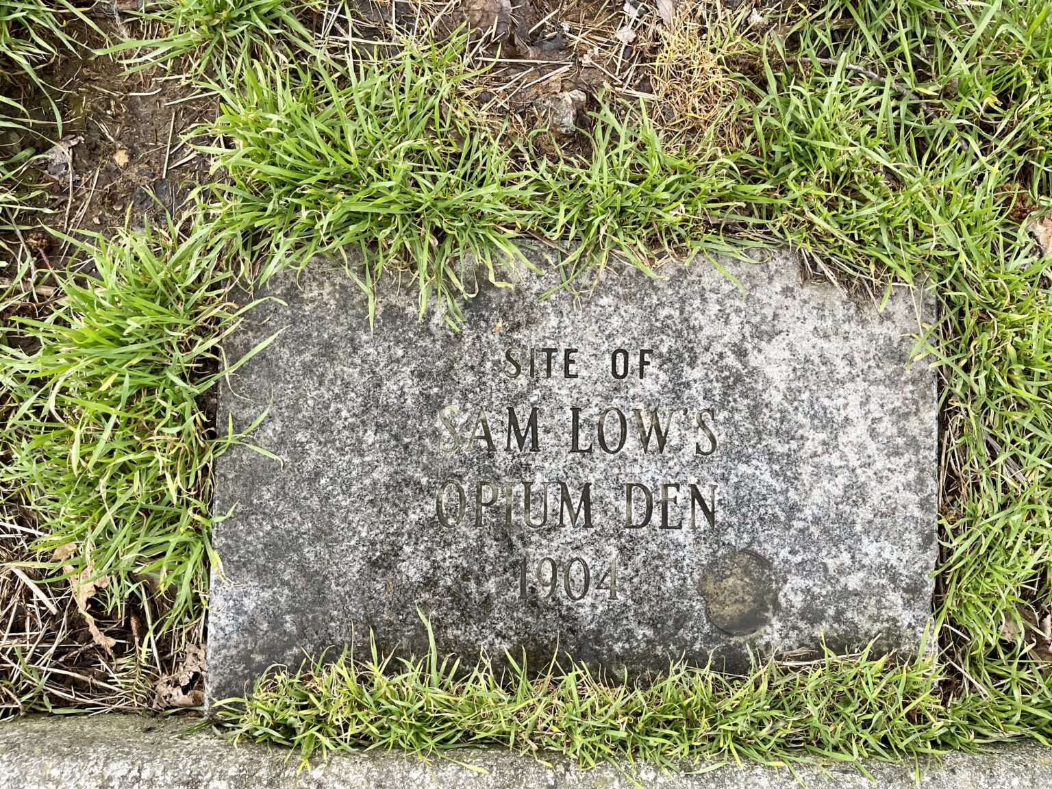 A marker near the Amtrak station in Fairhaven surrounded by grass.