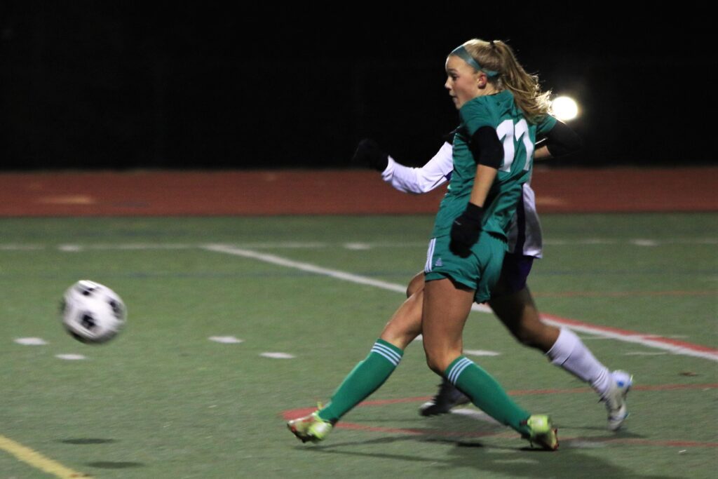 Freshman forward Ryan Boehm (11) battles for control of the ball with another player.