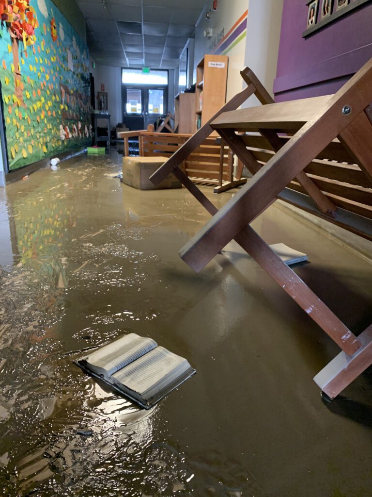 Waterlogged books and furniture cover a hallway in the old Sumas Elementary.