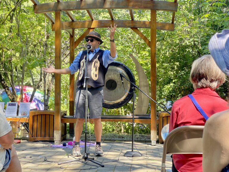 Swil Kanim, a native storyteller and classically trained violinist performs on stage for the crowd.