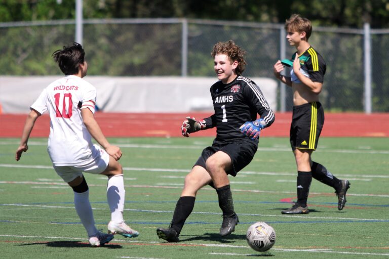 Archbishop Murphy goalkeeper Cam Ilgenfritz run up to her teammate as another player slows down nearby.