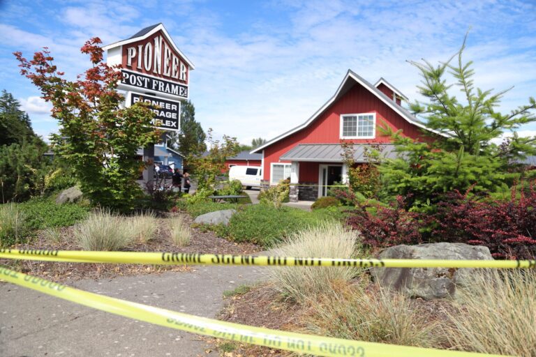 The red residential building at Pioneer Post Frame in Ferndale blocked off with police tape.