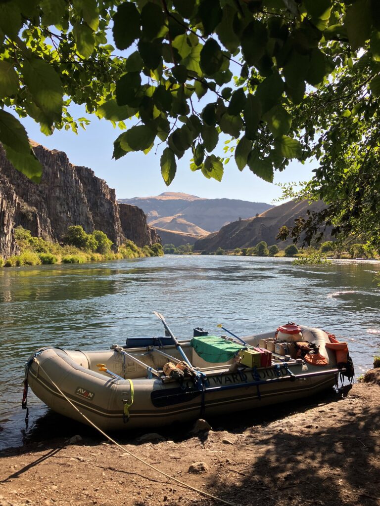 A sturdy raft with paddles and supplies.