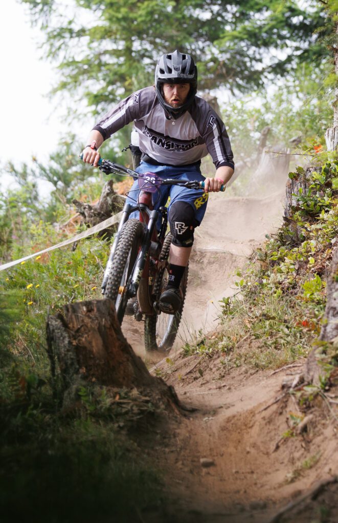 Kristian Duft focuses on maneuvering his bike through the small path and leaving a trail of dirt behind.