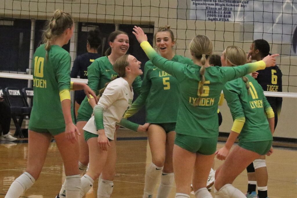 Lynden celebrates a point with her team after scoring.