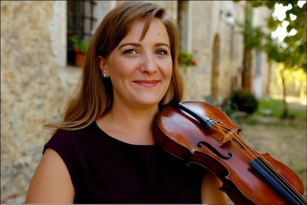 Violist Lindsey Strand-Polyak with her violin on her shoulder.