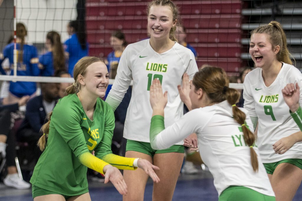 Lynden players celebrate with low-fives and smiles.