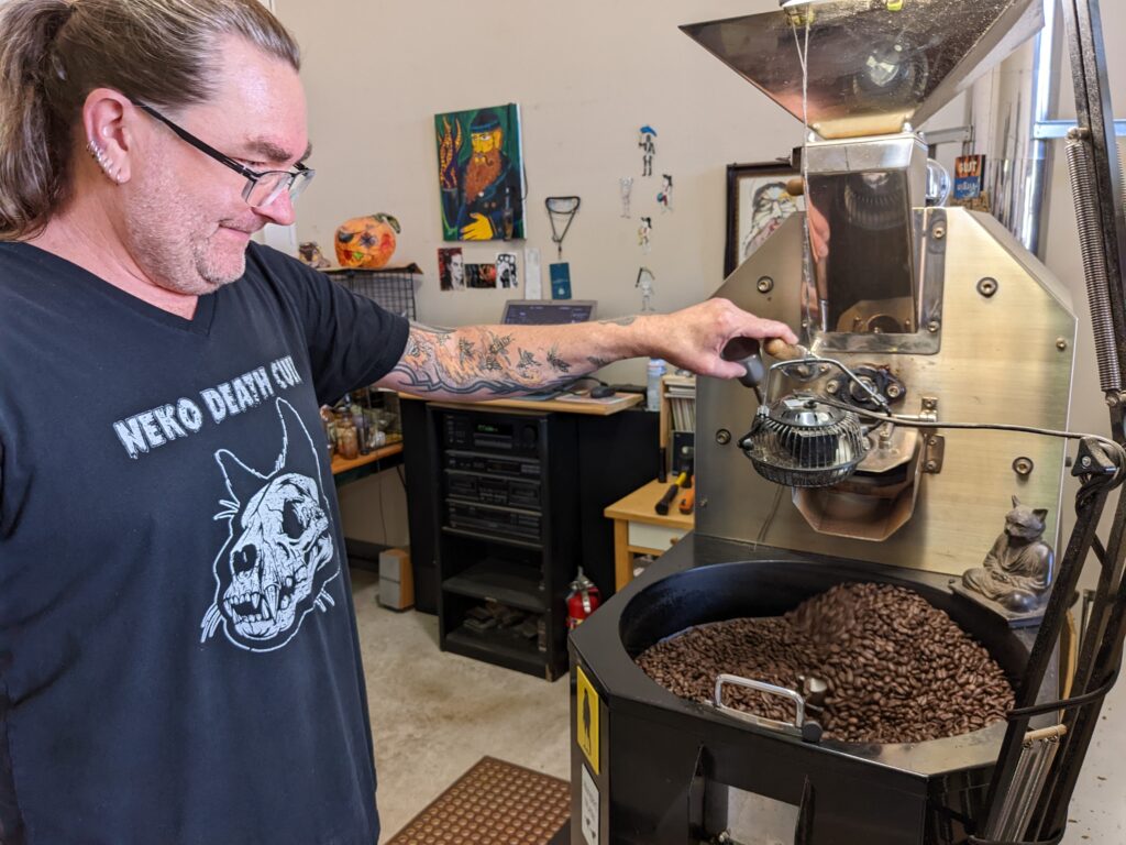 Alexarc Mastema, co-owner of Maniac Coffee Roasting, works the roaster.