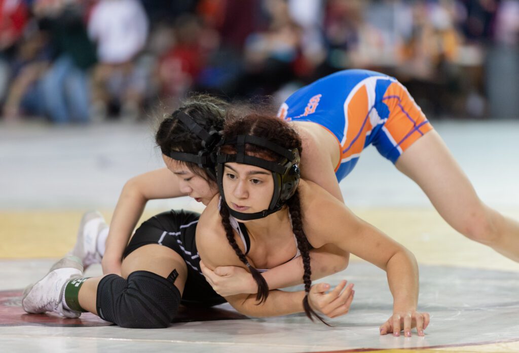 Blaine's Genesis Vazquez squirms to escape from Ridgefield's Uruwa Abe.