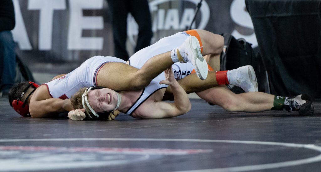 Blaine's Cael Button tries to avoid a pin as he makes an expression.