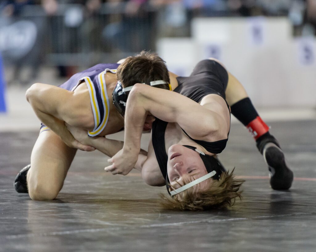 Mount Baker's Jorey Johnson tries to scramble out of a takedown by Wapato's Luis Barajas as he pushes with his legs to lift his body off the mat.