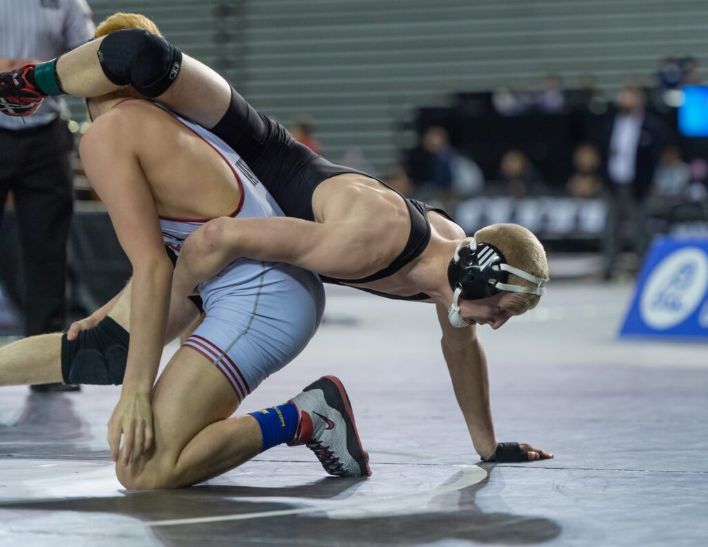 Mount Baker's Elijah Washburn tries to climb out of the grip of Toppenish's Abel Nava from behind him.