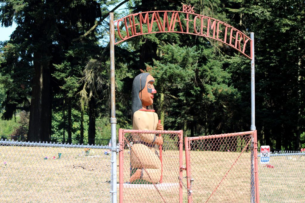 The Chemawa Indian School Cemetery with a sculpture standing at the center.