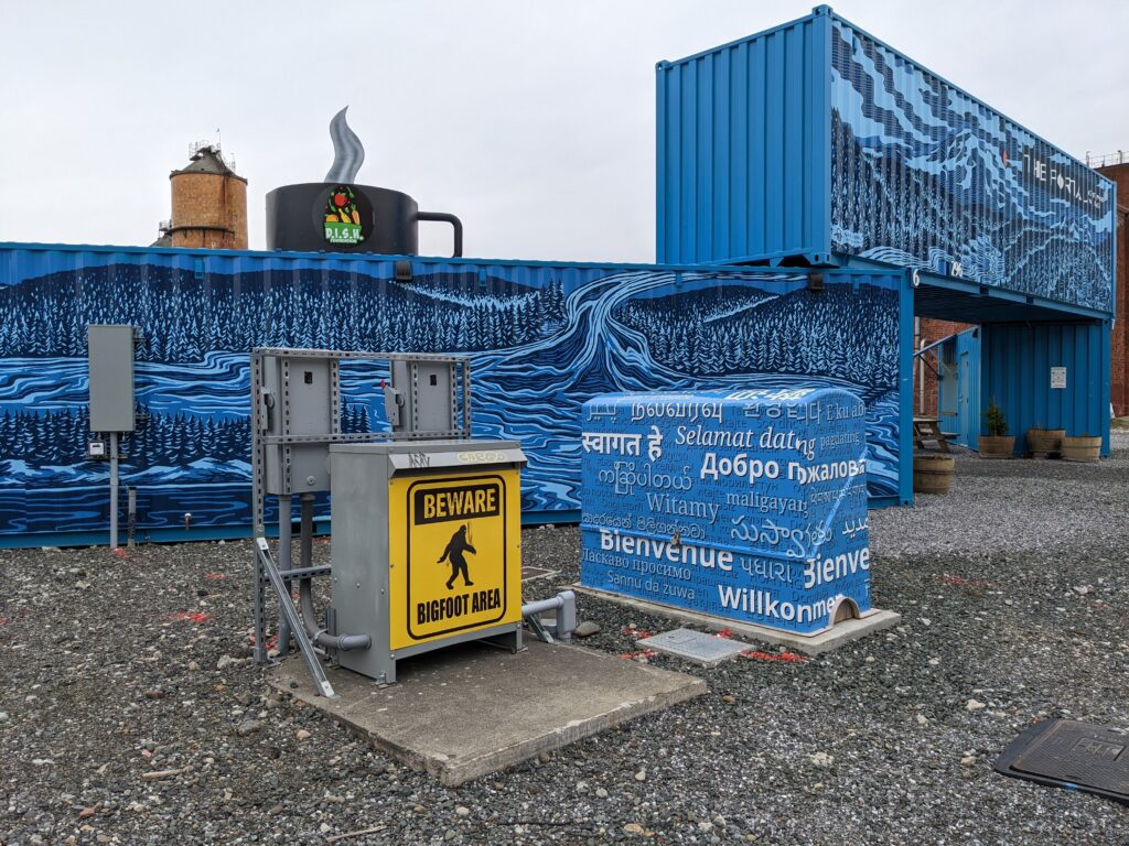 The entrance of The Portal Container Village on Bellingham's waterfront has blue containers with stylized graphics.