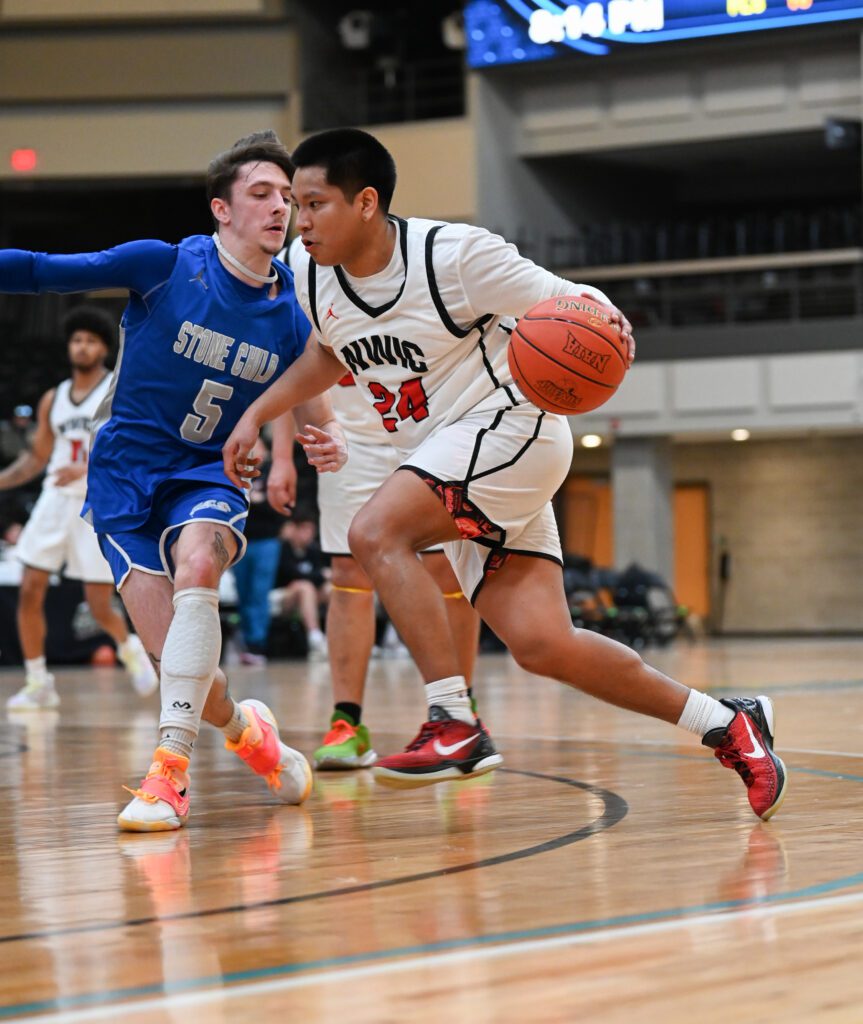 Malachi Rogers drives past a defender with the ball in hand.