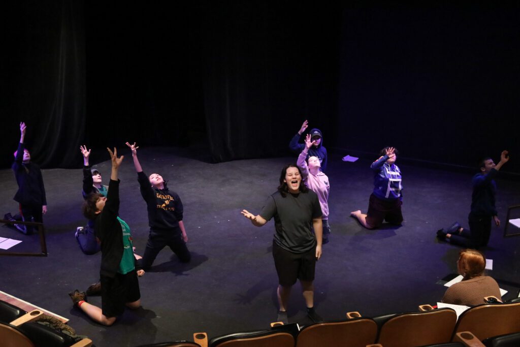 “Starmites the Musical” group performs on stage for a rehearsal.